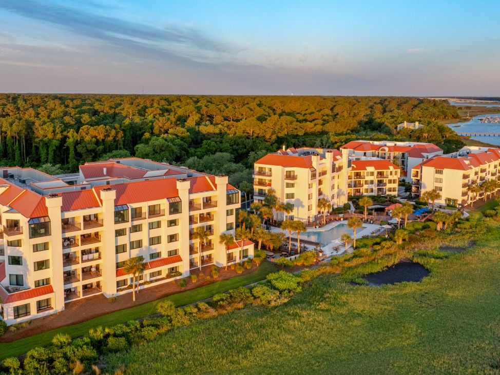 Exterior and grounds of Marriott's Sunset Pointe resort timeshare with pond fountain in foreground